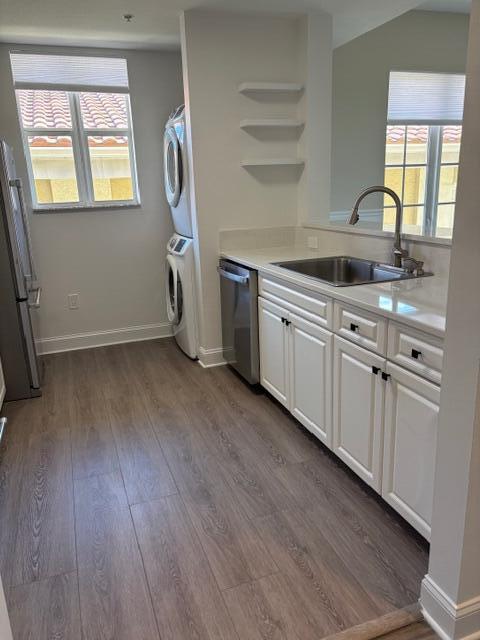 1200 Town Center Drive, Unit 427 Jupiter, FL 33458 - Photo 6 of 33 a kitchen with cabinets wooden floor and a window