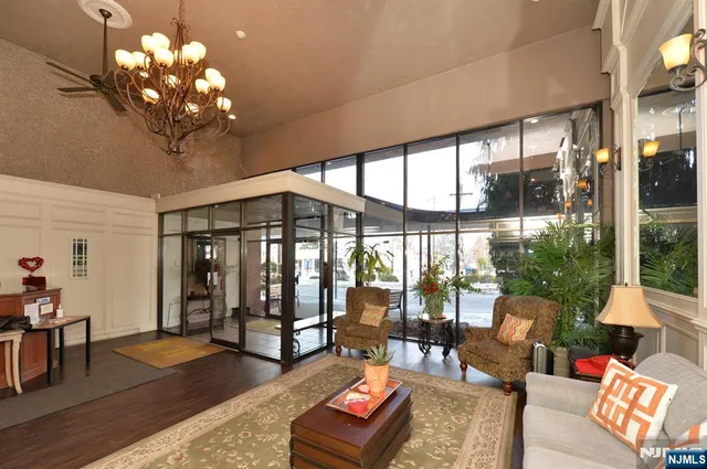 a living room with furniture and floor to ceiling windows