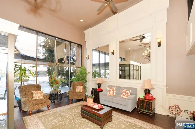 a living room with furniture and a chandelier