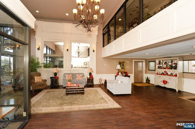 a hallway with wooden floor and white walls