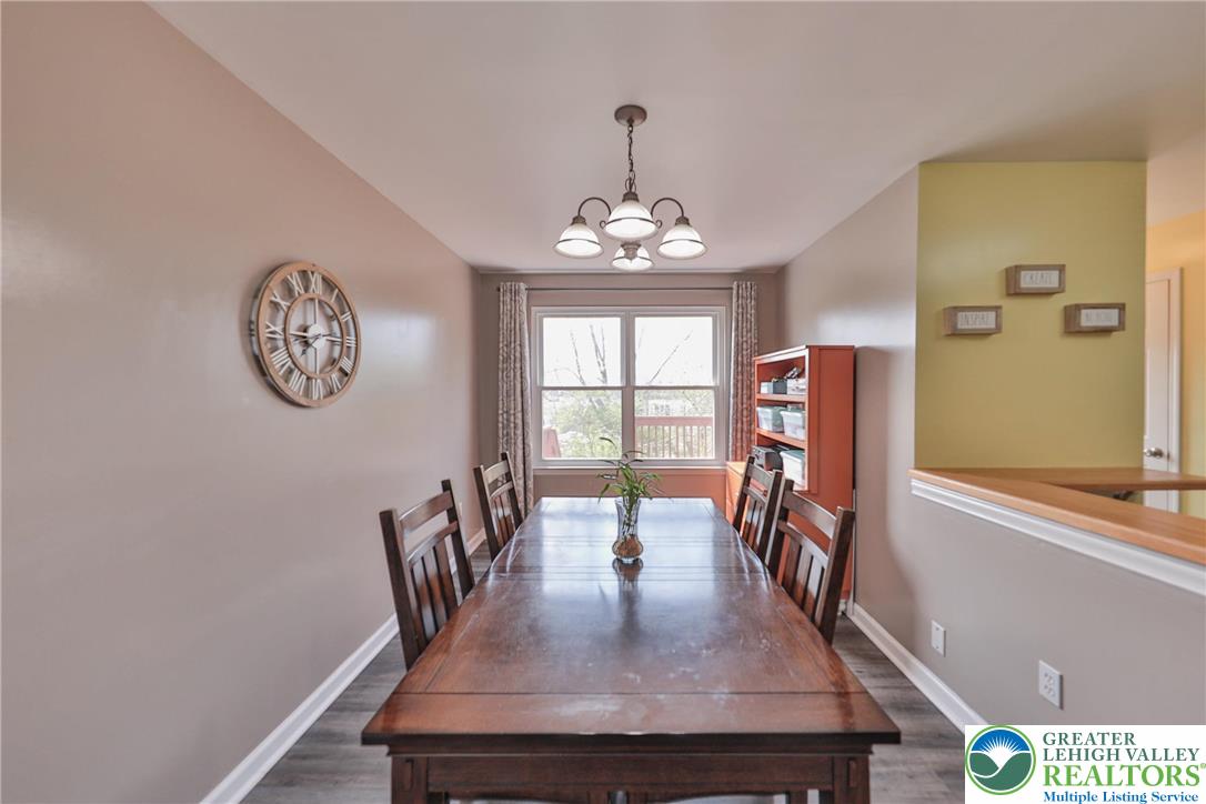 136 Cornerstone Place Whitehall, PA 18052 - Photo 16 of 39 a view of a dining room with furniture a chandelier and wooden floor