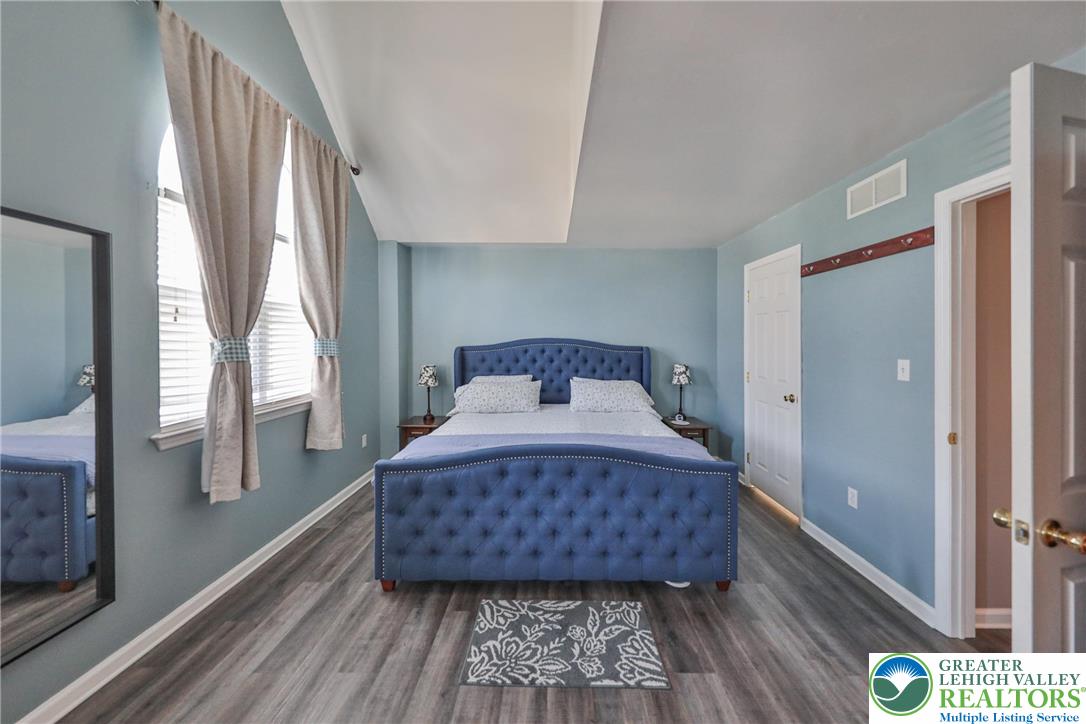 136 Cornerstone Place Whitehall, PA 18052 - Photo 27 of 39 a bedroom with a bed and wooden floor