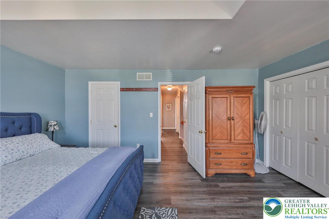 136 Cornerstone Place Whitehall, PA 18052 - Photo 29 of 39 a bedroom with a bed and wooden floor