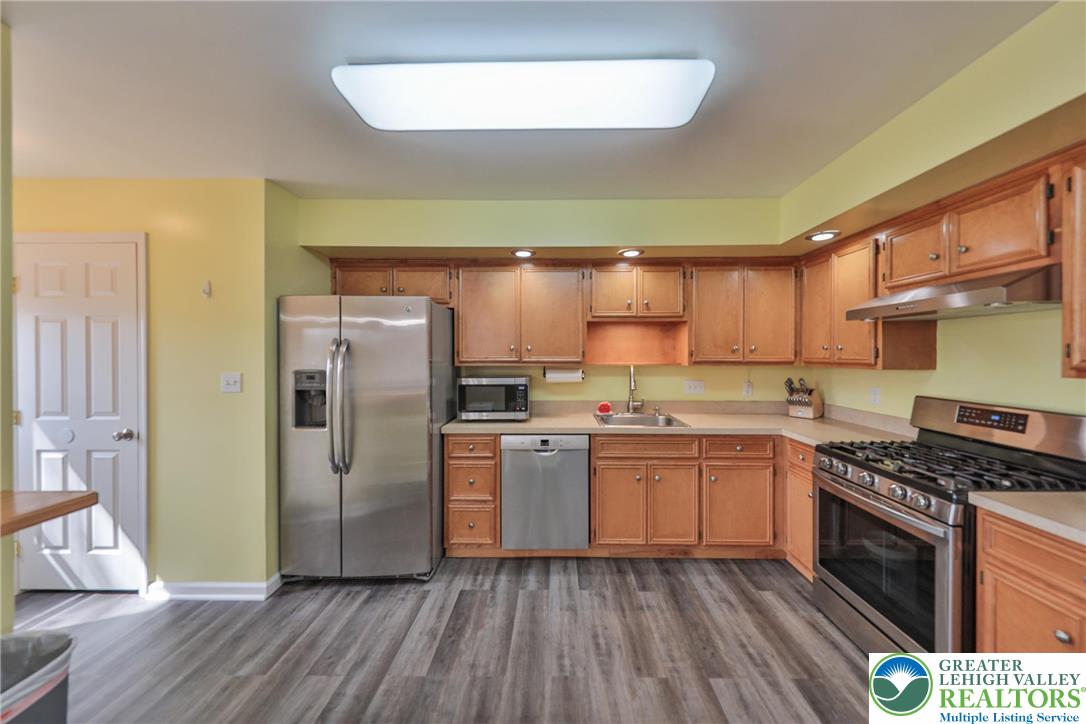 136 Cornerstone Place Whitehall, PA 18052 - Photo 8 of 39 a kitchen with a refrigerator a sink and wooden floor