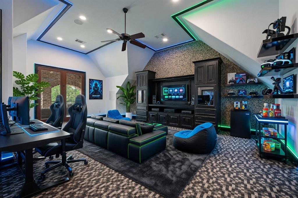 6900 Rockingham Court Colleyville, TX 76034 - Photo 26 of 40 2nd Floor of Guest House ADU features a built-in entertainment center with 2 fish tanks, patterned carpet, ceiling fan, large walk-in closet, and covered balcony with swing. Ai staged.