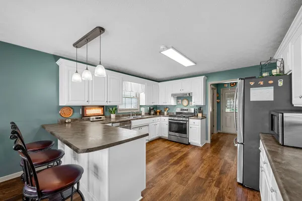 a kitchen with a stove a refrigerator and a fireplace