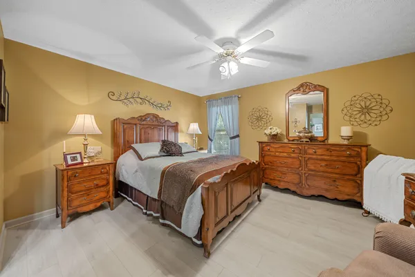 a bedroom with a bed and ceiling fan