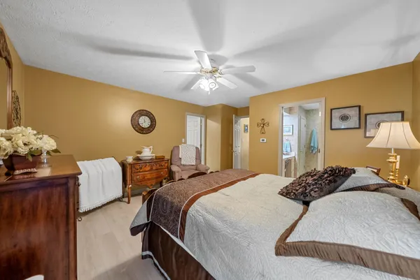 a bedroom with a bed and a chandelier