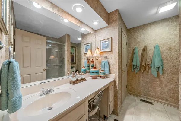 a bathroom with a double vanity sink a mirror and shower