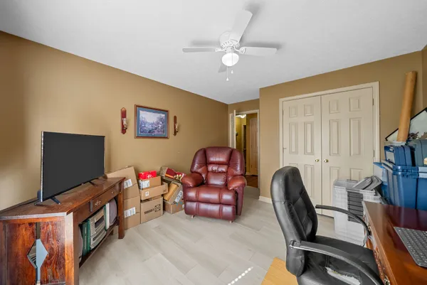 a view of a workspace with furniture and a window