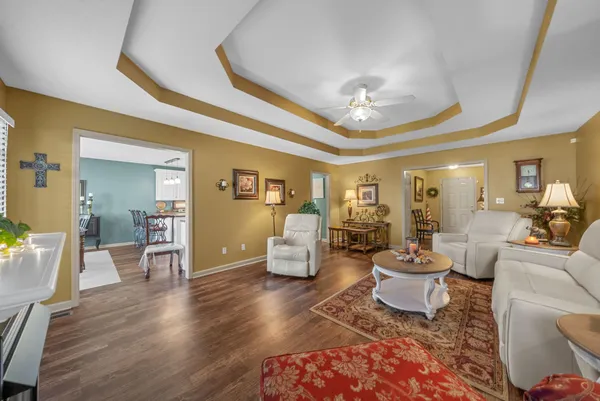 a living room with furniture and wooden floor