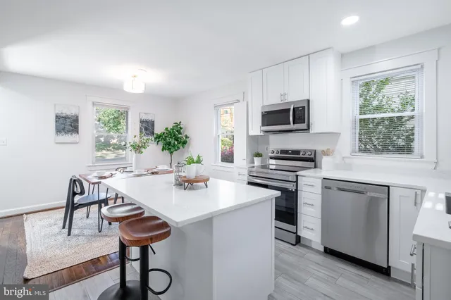 a kitchen with a stove a sink and a refrigerator