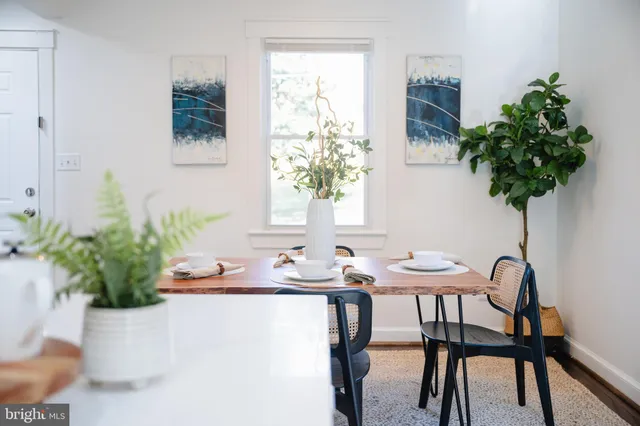 a view of a workspace with a table and chair in a room