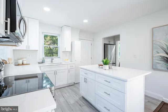 a kitchen with stainless steel appliances a sink stove and microwave