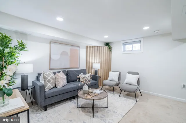 a living room with furniture and a large mirror