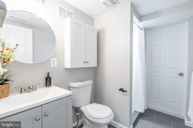 a bathroom with a shower and a sink