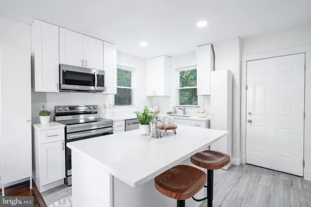 a kitchen with a sink a stove and a refrigerator