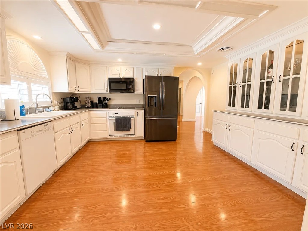 3010 East Viking Road Las Vegas, NV 89121 - Photo 25 of 48 Spacious cooking area with bright wood floors and white cabinetry.