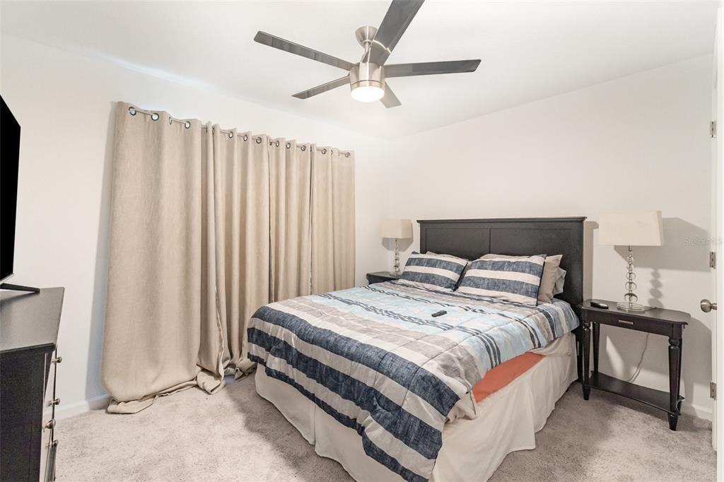 7065 North Heritage Drive Dunnellon, FL 34434 - Photo 11 of 30 a bedroom with a bed and a chandelier