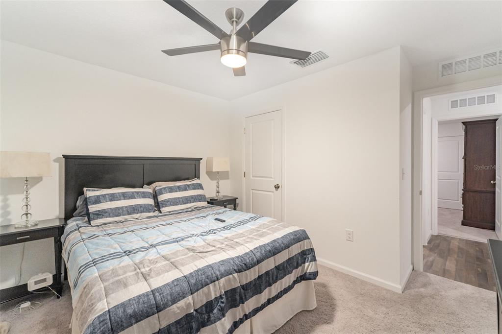 7065 North Heritage Drive Dunnellon, FL 34434 - Photo 12 of 30 a bedroom with a bed and a ceiling fan
