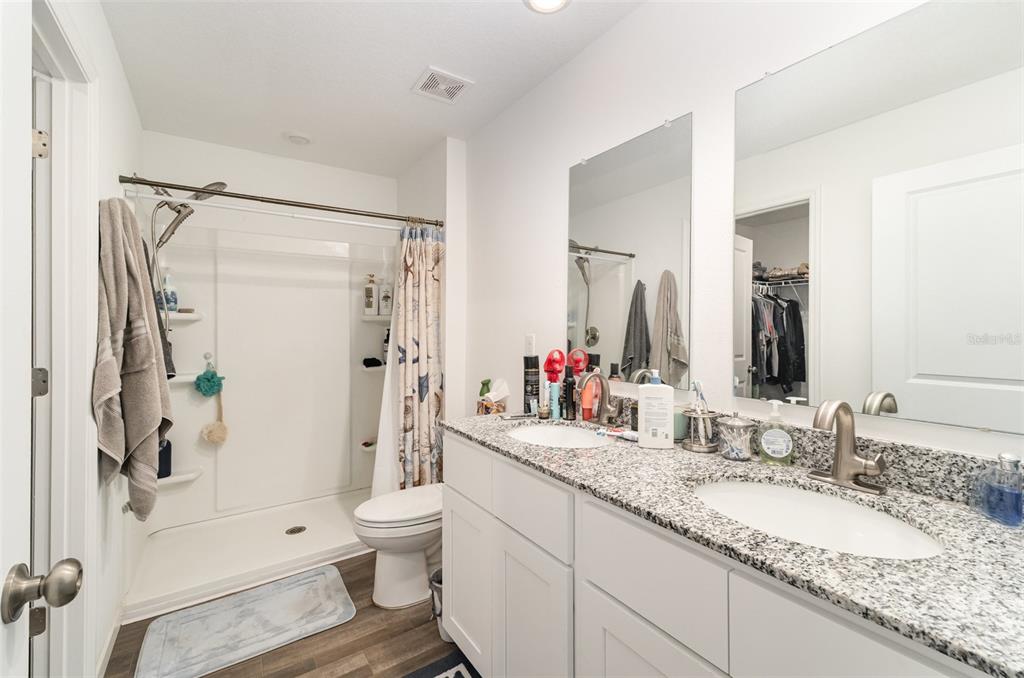 7065 North Heritage Drive Dunnellon, FL 34434 - Photo 22 of 30 a bathroom with a granite countertop sink toilet and shower