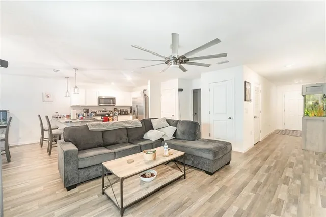 a living room with furniture and a wooden floor