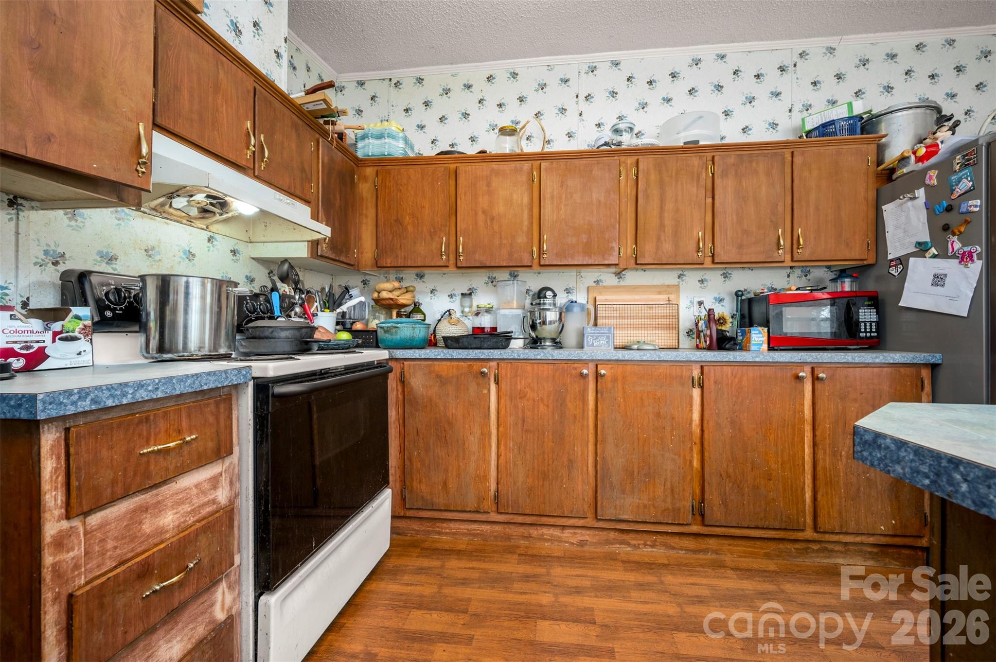 220 Mt Harmony Church Road Lawndale, NC 28090 - Photo 12 of 48 a kitchen with stainless steel appliances granite countertop a sink wooden cabinets and a counter top space