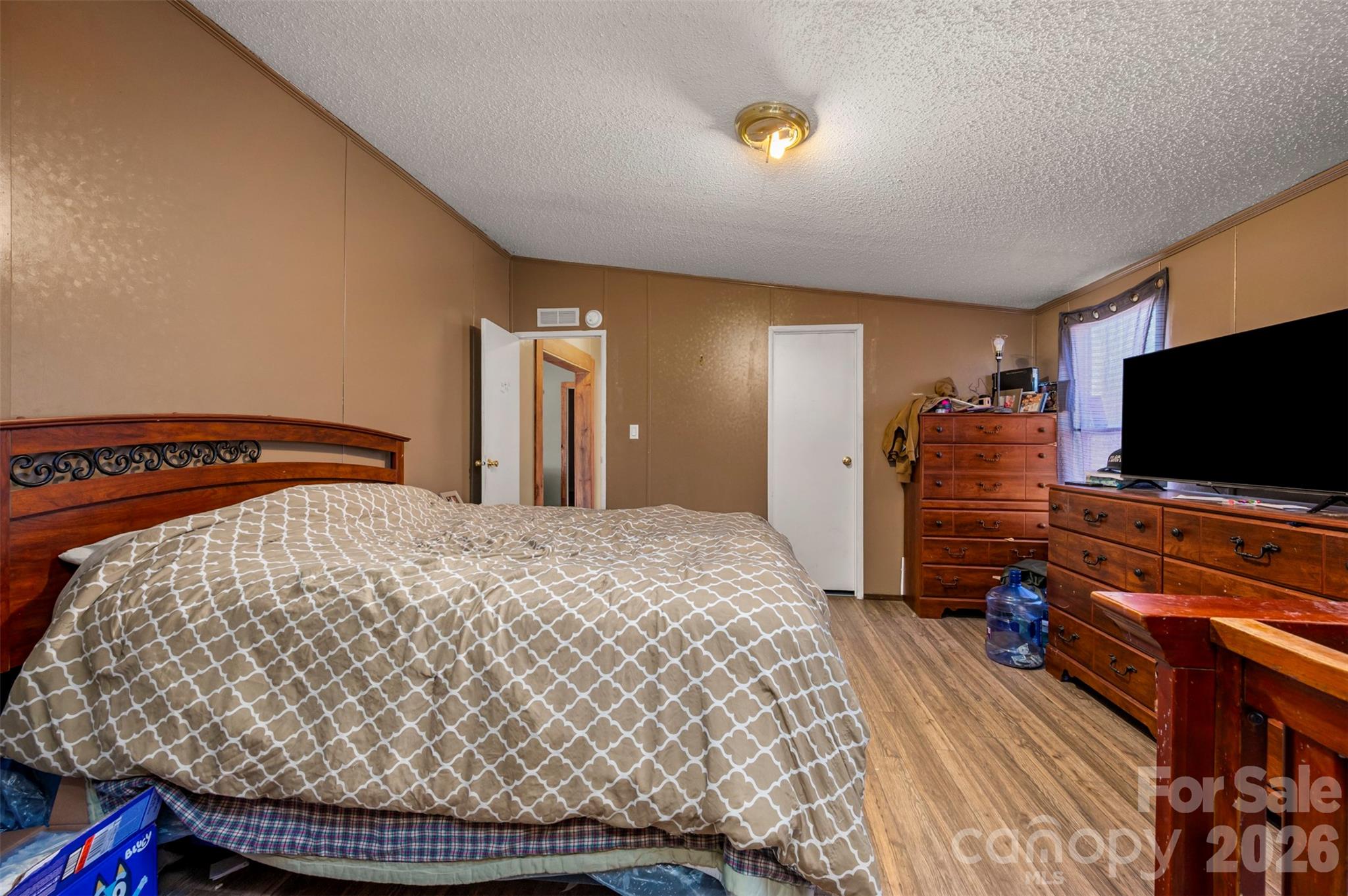 220 Mt Harmony Church Road Lawndale, NC 28090 - Photo 15 of 48 a bedroom with a bed and a flat screen tv