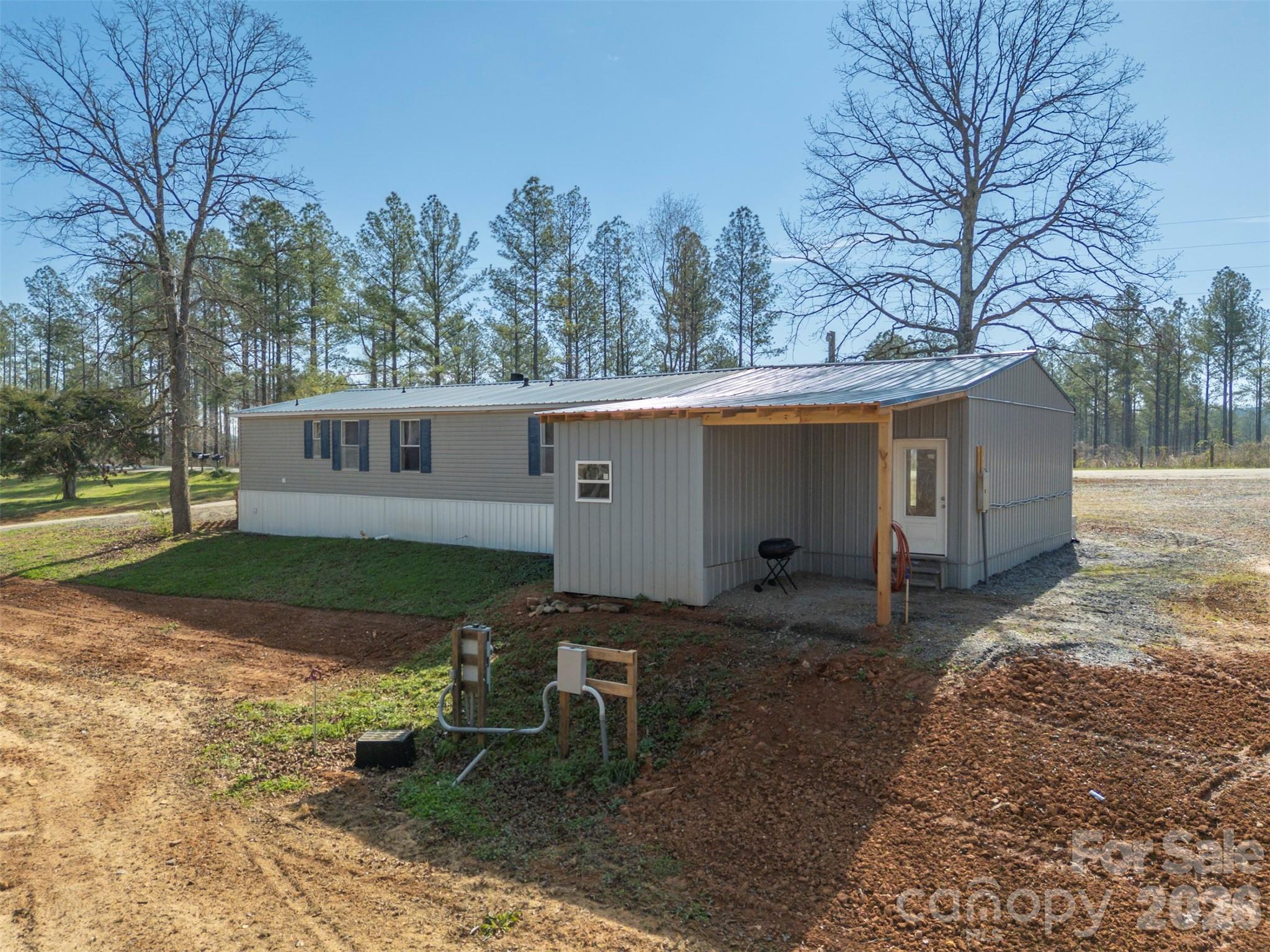 220 Mt Harmony Church Road Lawndale, NC 28090 - Photo 32 of 48 a view of a house with backyard