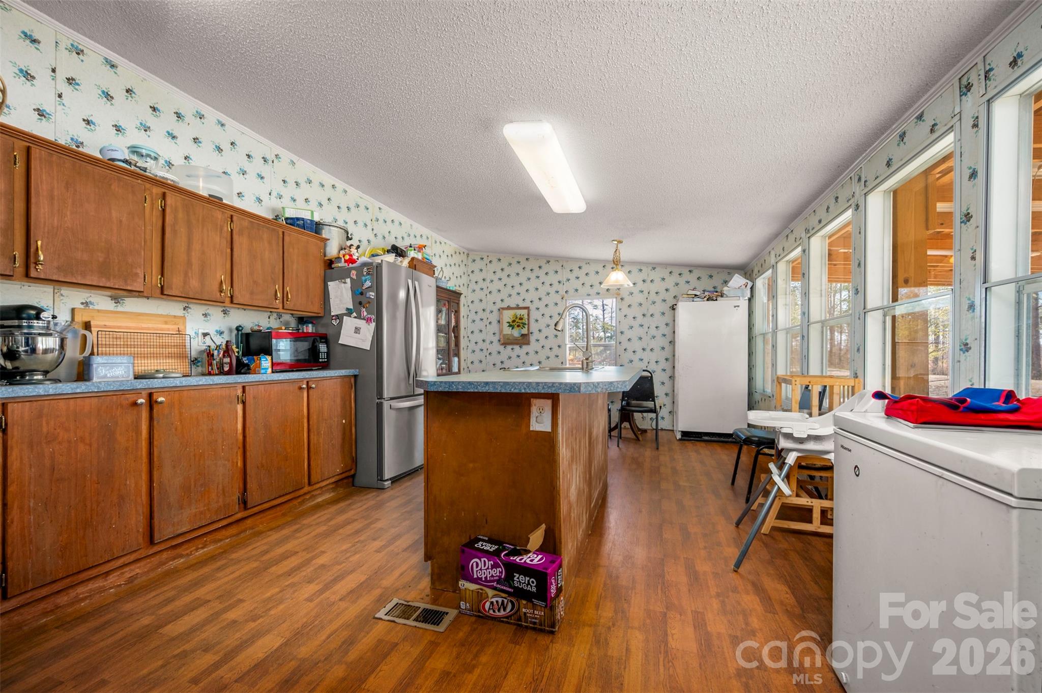 220 Mt Harmony Church Road Lawndale, NC 28090 - Photo 10 of 48 a room with wooden floors stairs and a large window