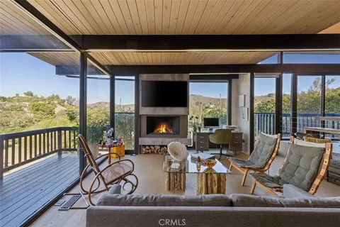 a living room with furniture and floor to ceiling windows