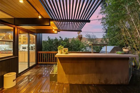 a view of a house with wooden fence