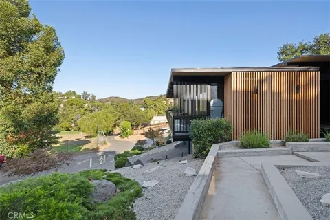 a view of a porch with couches table and chairs and wooden floor