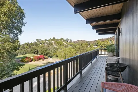 a kitchen with a stove and wooden floor