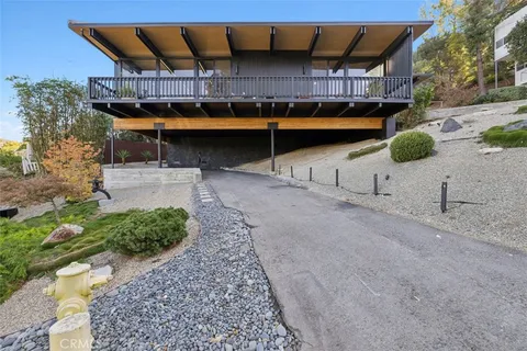a view of a yard with wooden fence