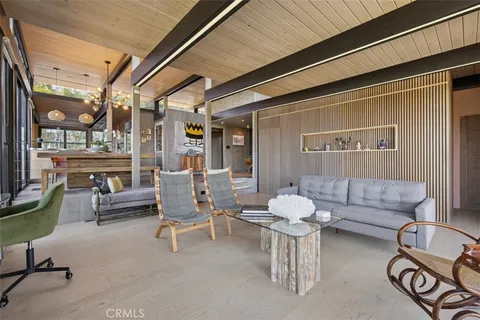 a living room with patio furniture and a fireplace