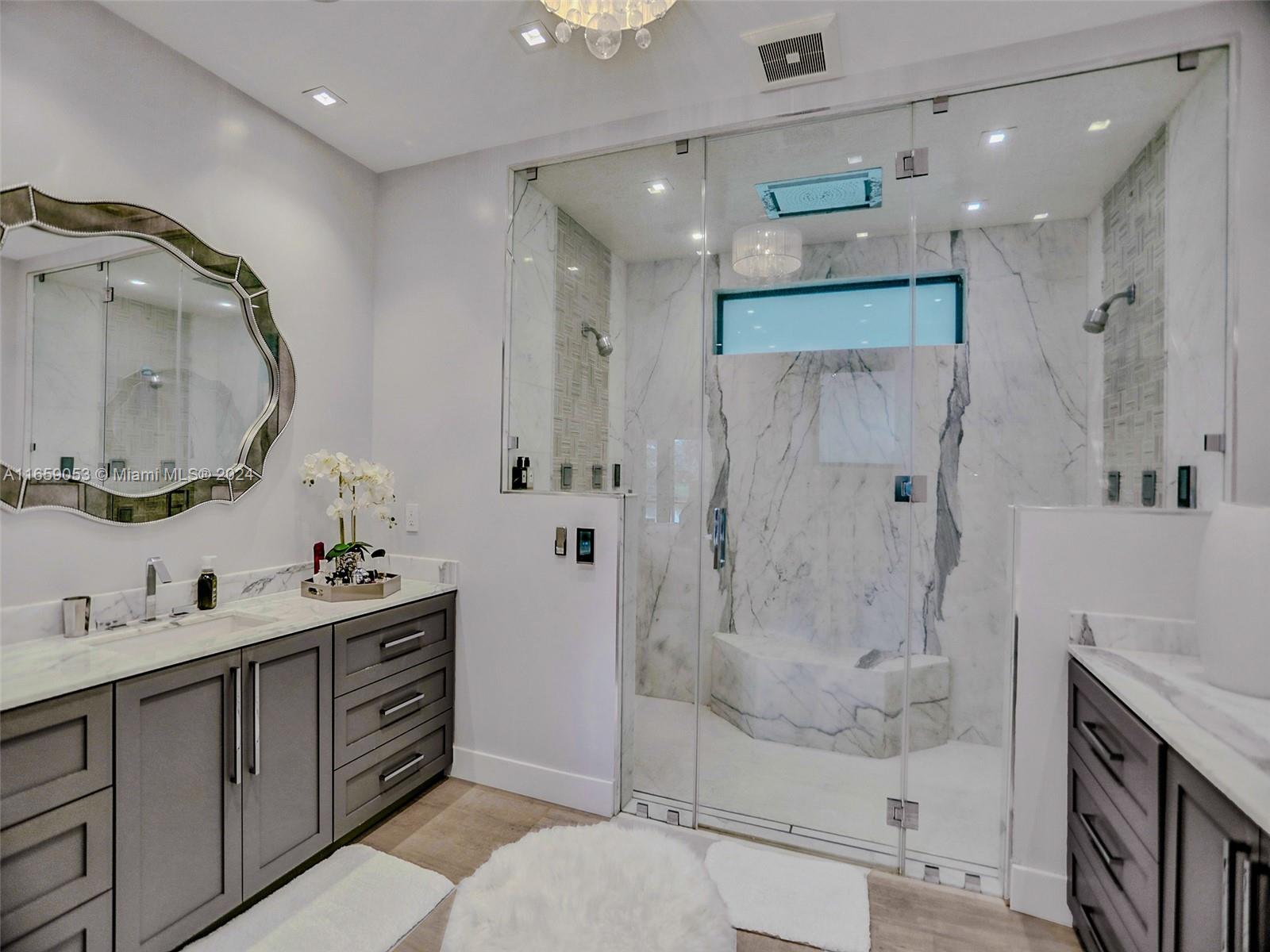 20221 Southwest 48th Place Southwest Ranches, FL 33332 - Photo 15 of 42 a bathroom with a double vanity sink mirror double shower and a mirror