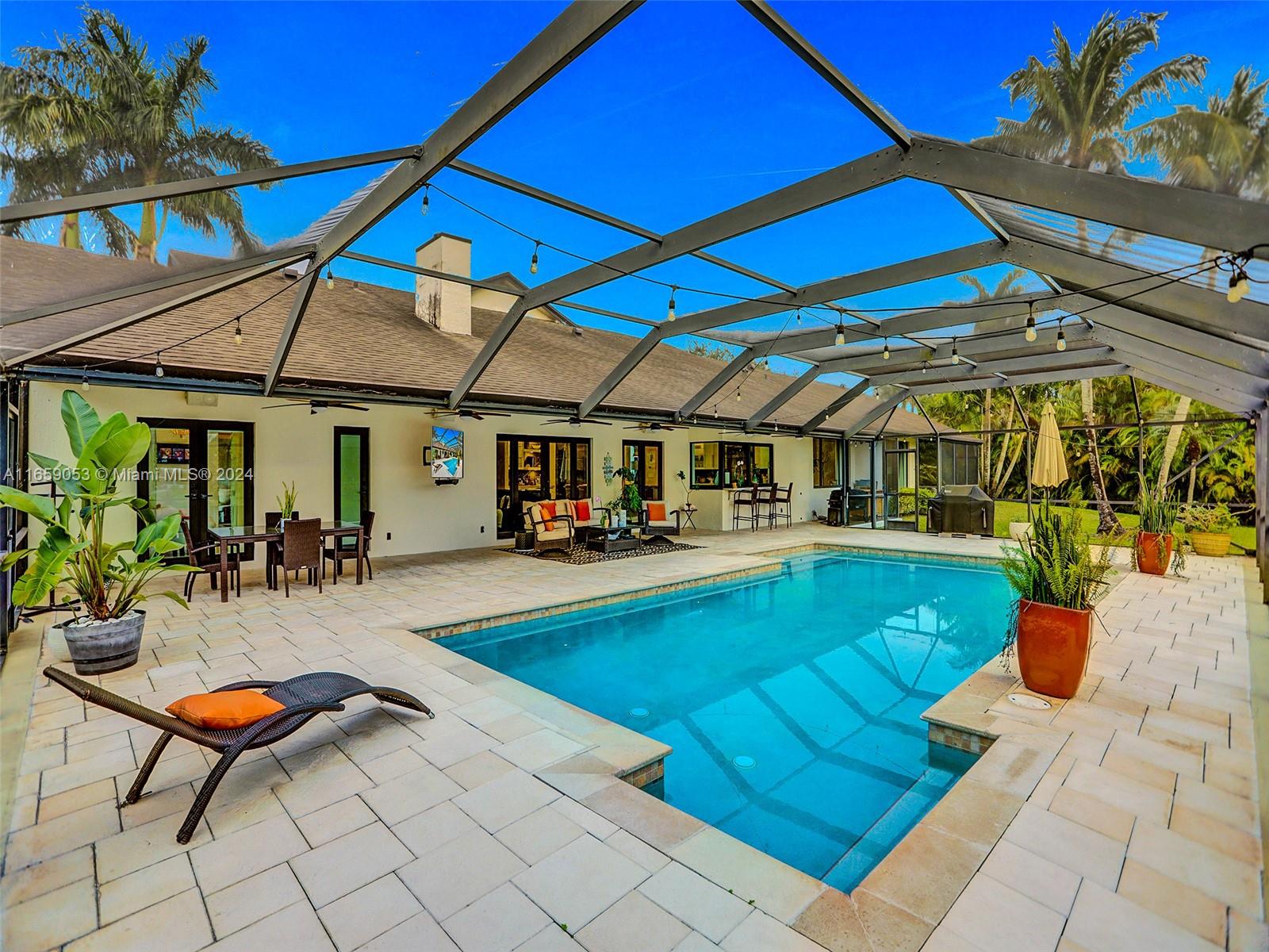 20221 Southwest 48th Place Southwest Ranches, FL 33332 - Photo 20 of 42 a view of a swimming pool with a patio