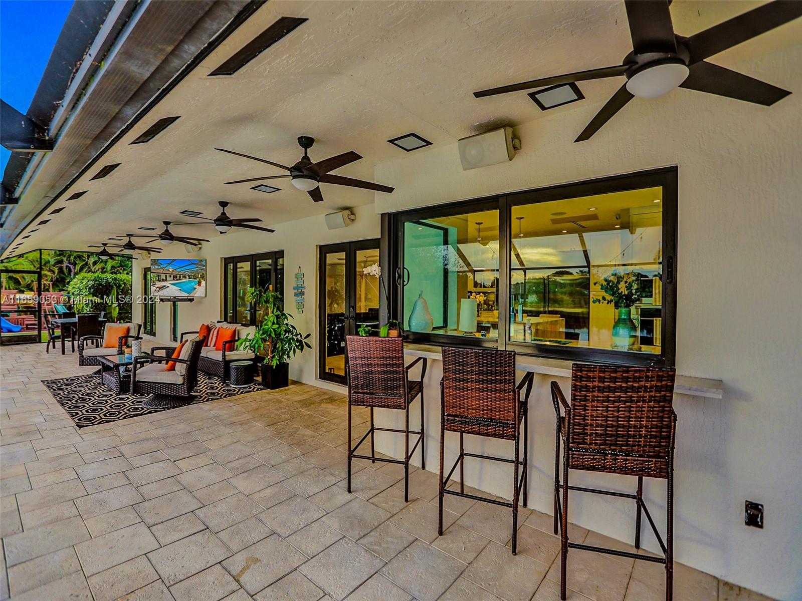 20221 Southwest 48th Place Southwest Ranches, FL 33332 - Photo 30 of 42 a view of a patio with table and chairs