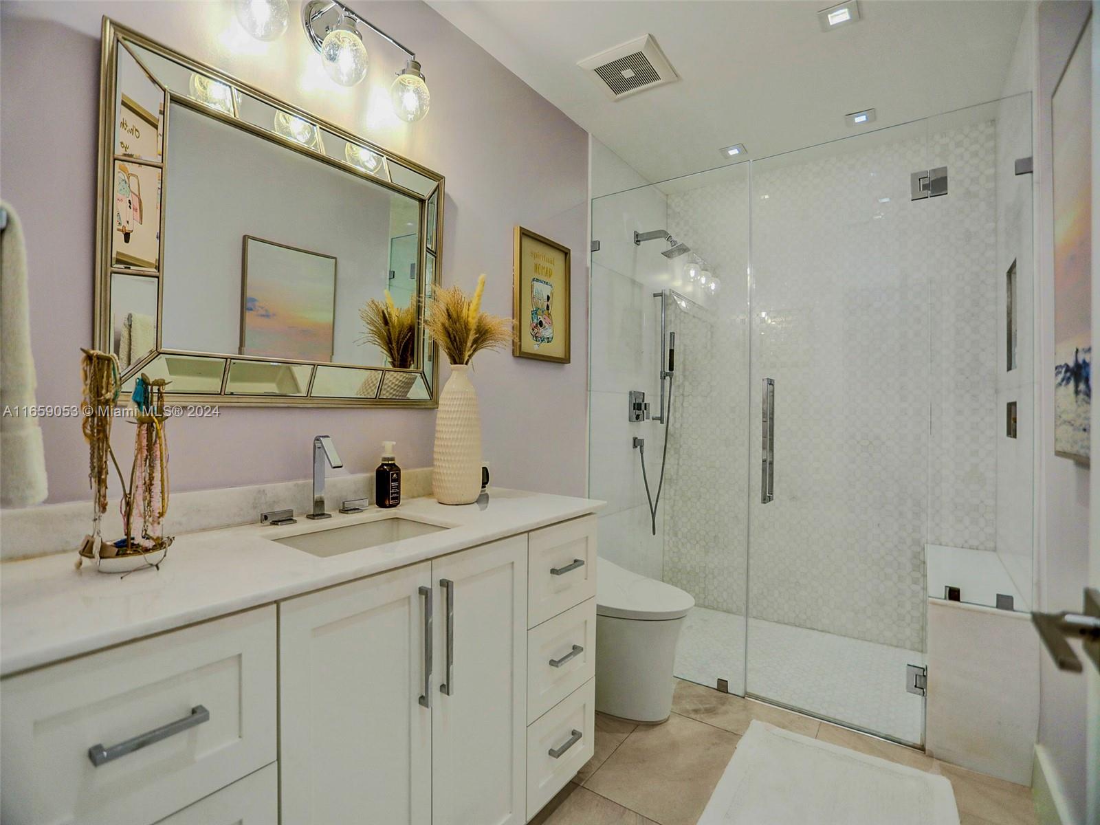 20221 Southwest 48th Place Southwest Ranches, FL 33332 - Photo 35 of 42 a bathroom with a double vanity sink mirror double and shower