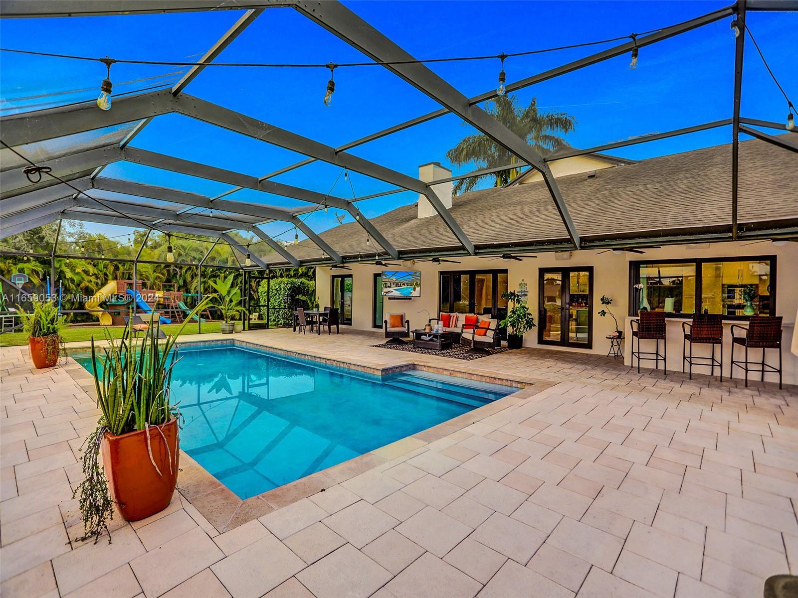 20221 Southwest 48th Place Southwest Ranches, FL 33332 - Photo 10 of 42 a view of a swimming pool with a patio