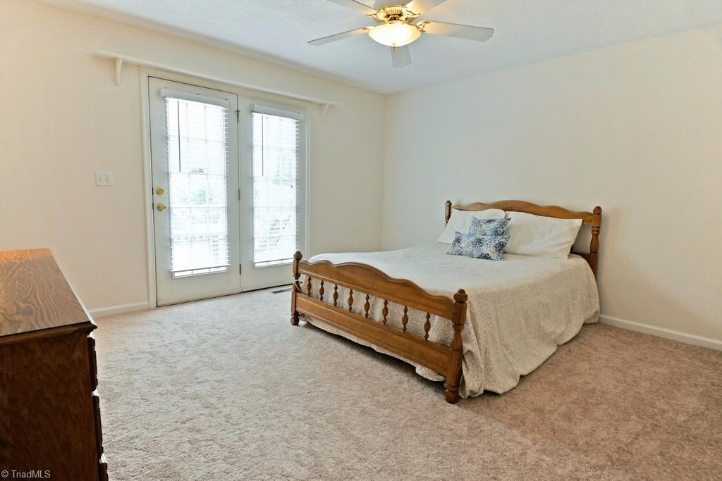 7548 Strawberry Road Summerfield, NC 27358 - Photo 14 of 20 Master suite with bath and French doors to the outside deck...