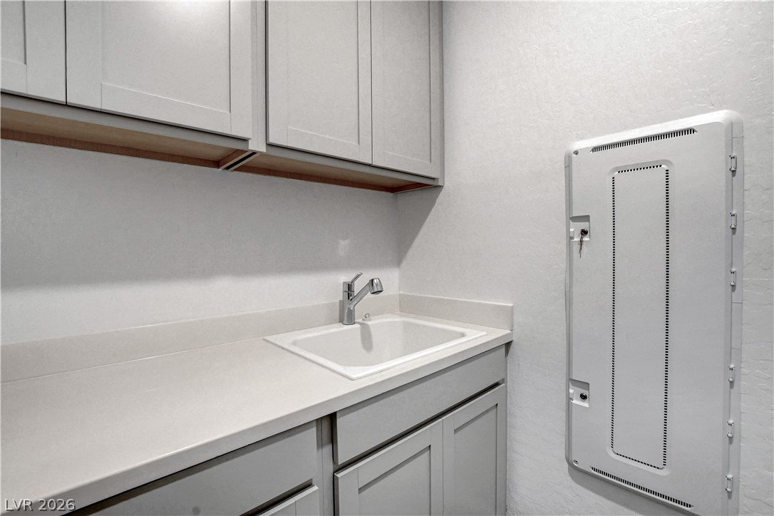 2555 Hampton Road, Unit 2207 Henderson, NV 89052 - Photo 35 of 74 Well-appointed utility room featuring a practical sink and ample cabinetry for storage.