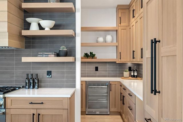 a kitchen with a sink a stove and cabinets