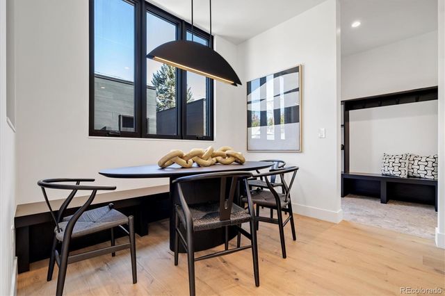 a view of a dining room with furniture window and wooden floor