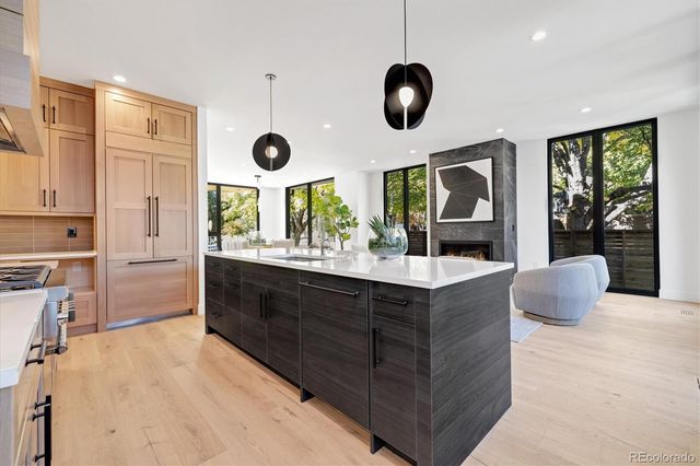 a kitchen with stainless steel appliances granite countertop a stove and a large refrigerator