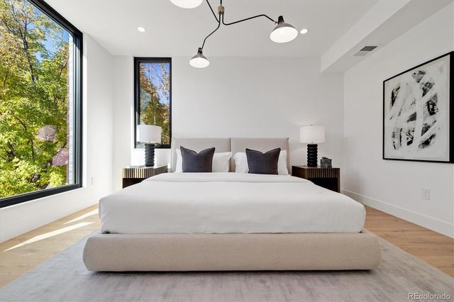 a bedroom with a large bed and a large window