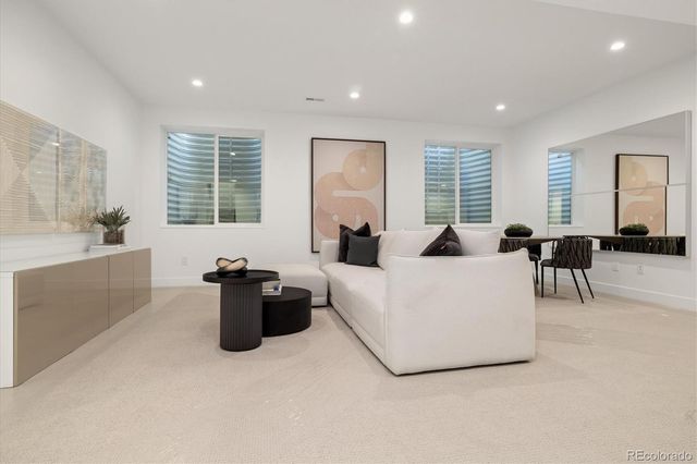 a living room with furniture and large windows