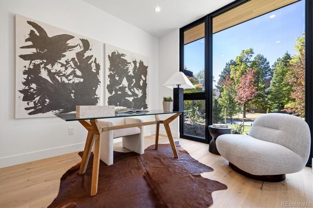 a living room with furniture and a painting on the wall