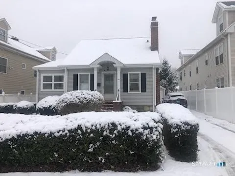 a view of a house with a yard covered in snow